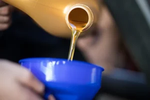 Pouring oil into blue funnel
