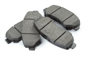 Brand new brake pads sitting on white background