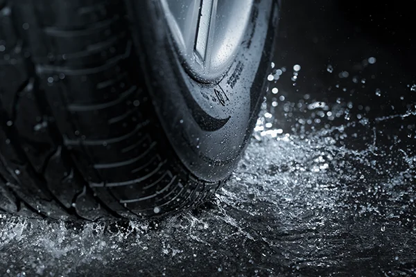 Close up of tire driving on rain